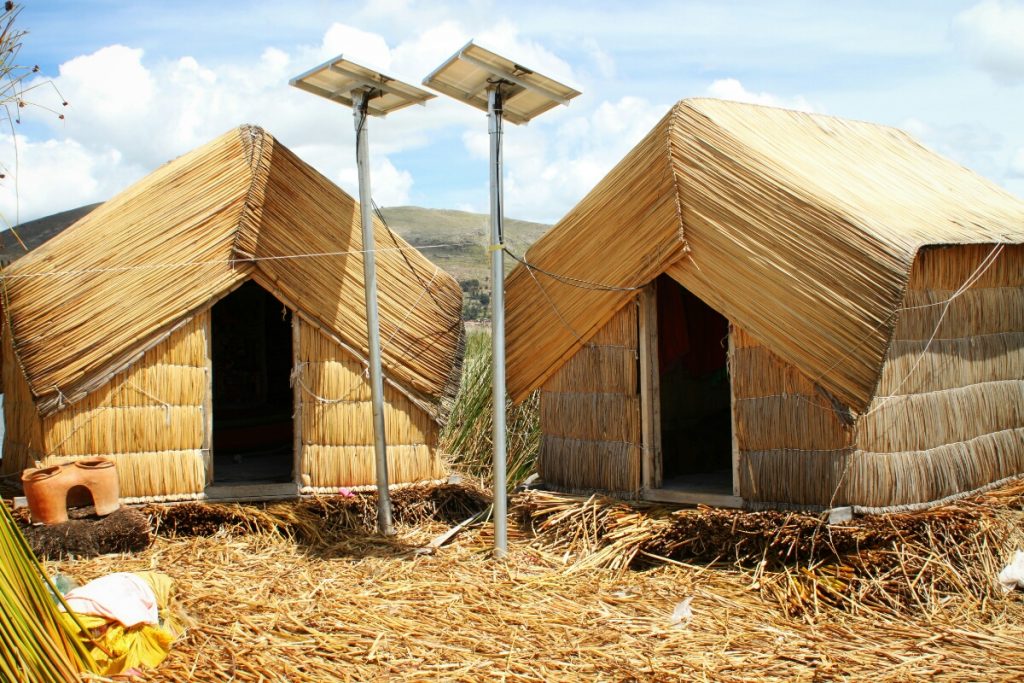 Reed huts. The solar panels are only a couple of months old and means they aren't using candles in their highly flammable homes